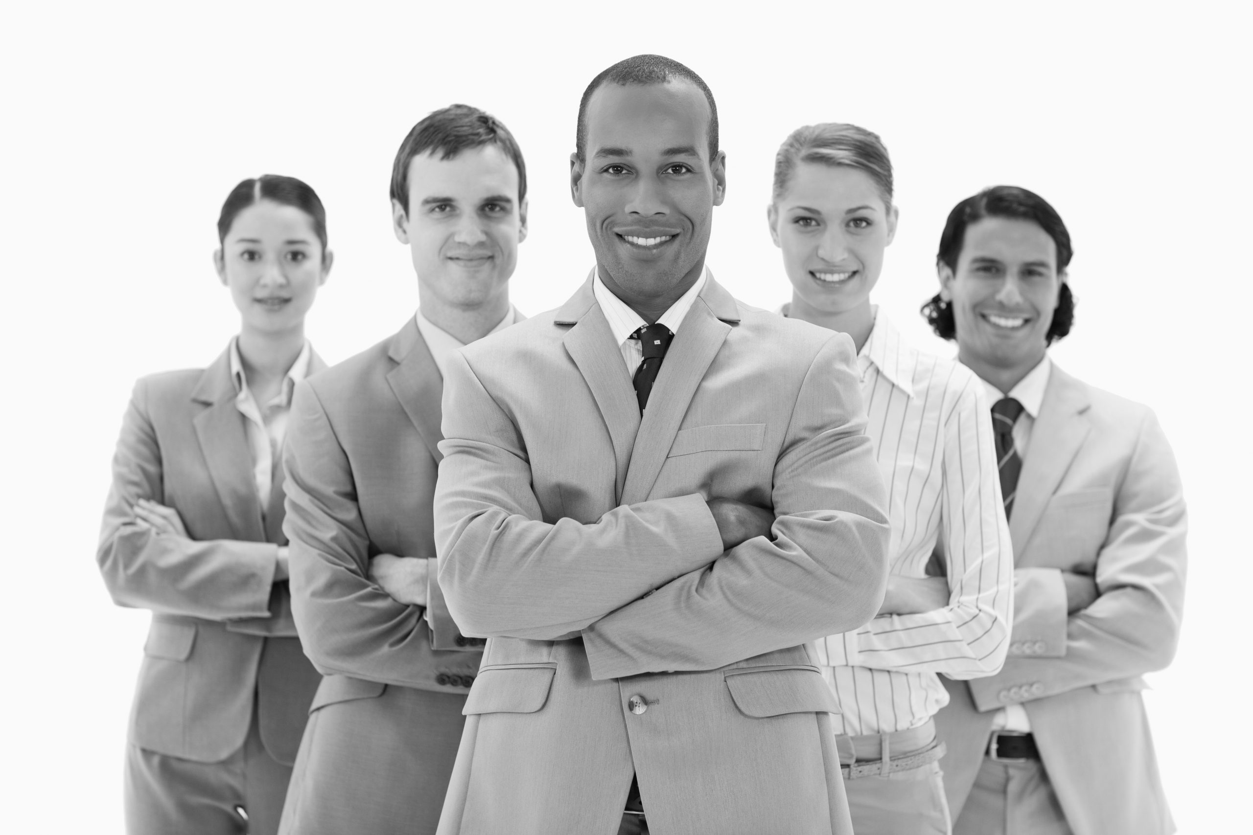 Close-up of a business team smiling and crossing their arms against white background